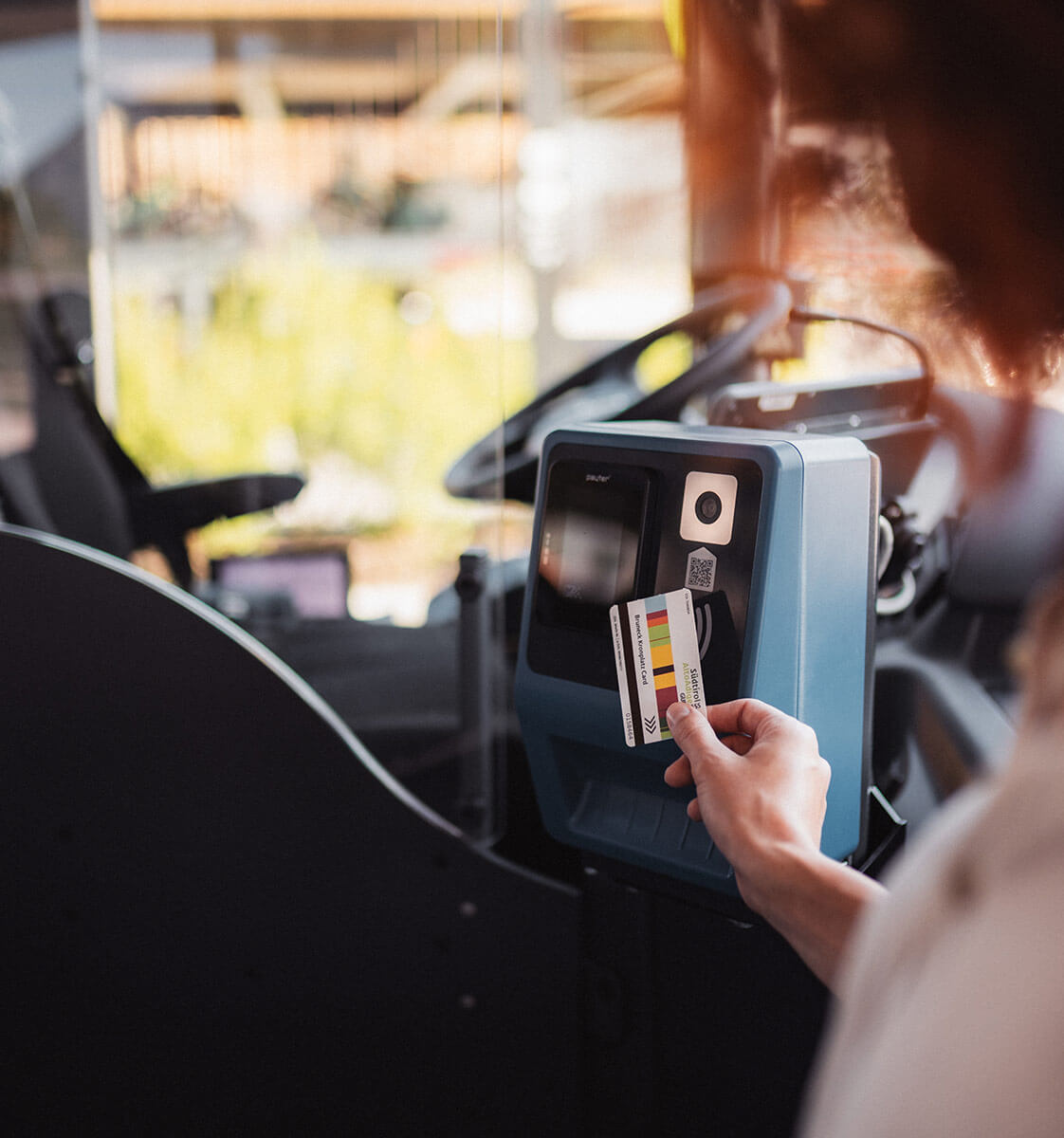 Woman stamps South Tyrol Pass at the machine - Klaudehof
